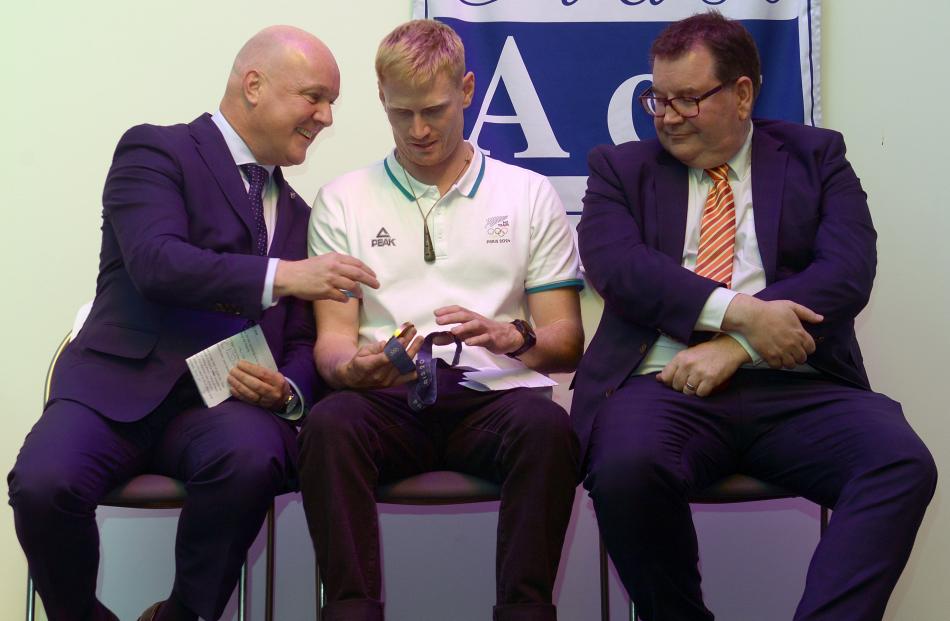 Prime Minister Christopher Luxon admires Paris Olympian Finn Butcher's gold medal as University...