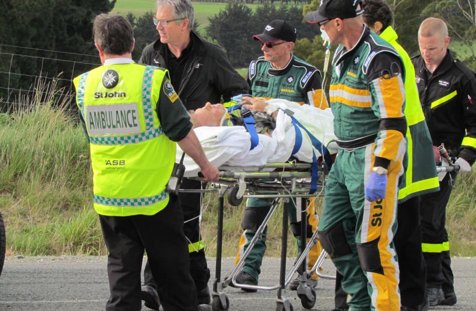 Airlift . . . The driver of the car is taken by medical personnel to the waiting Otago Regional...