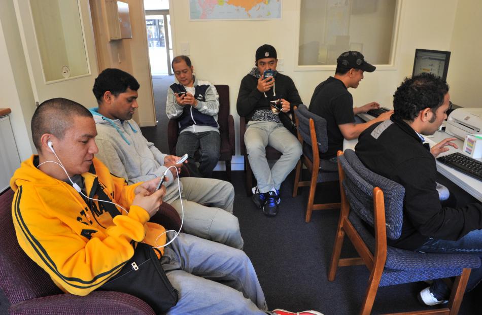 Cruise-ship crew (clockwise from left) Jeffrey Rubio, of the Philippines, Stephen Anthony, of...