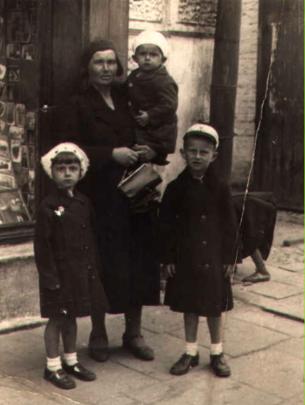 Janina Juchnowicz holding George, with his sister Mary and brother John standing by, in Brzesc,...