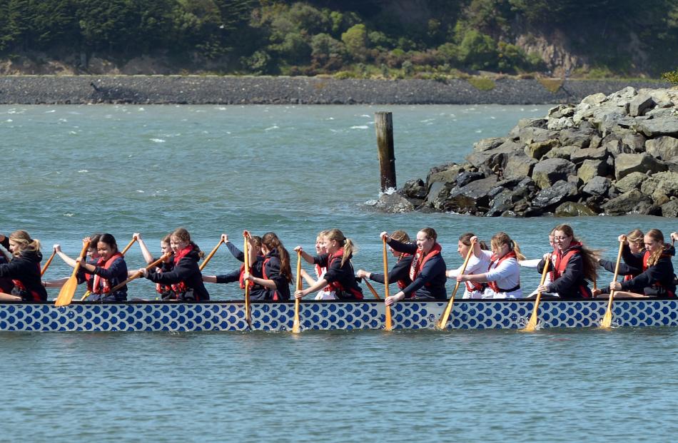 Queen’s High School students try their hand at dragon boating.