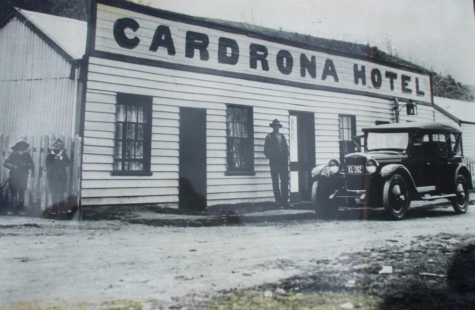 A similar car to the modern-day Cardrona Hotel's famous Chrysler is parked outside the hotel in...
