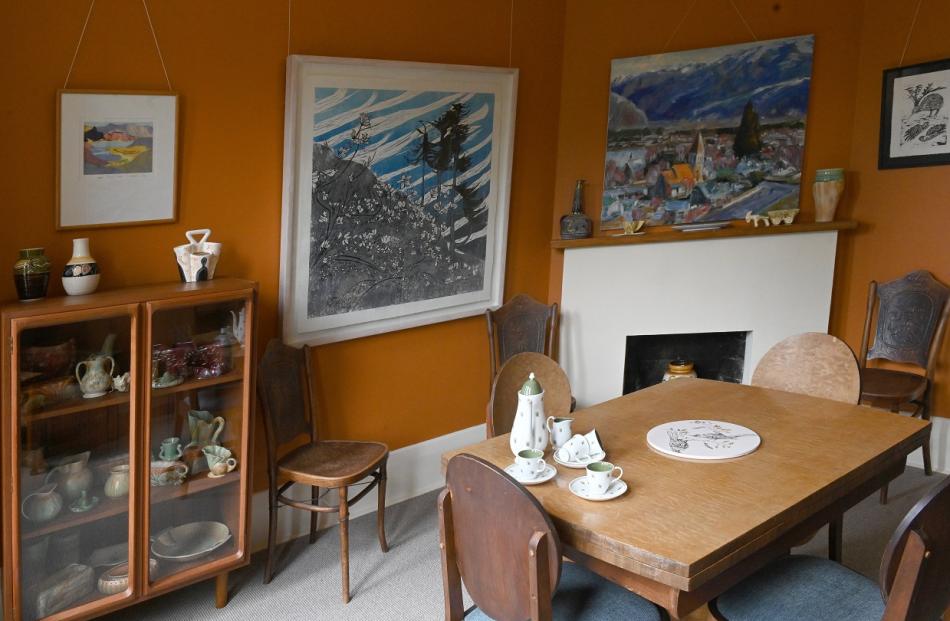The dining room features a 1930s dining suite and Selar Henderson’s collection of West German...