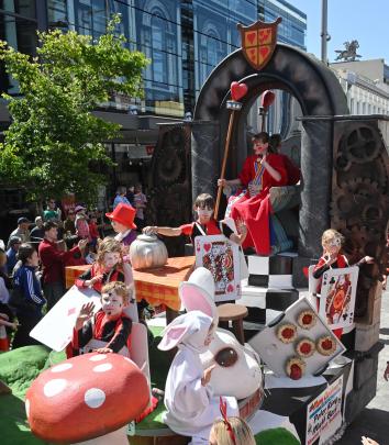 The Queen of Hearts presides over the Alice in Wonderland float.