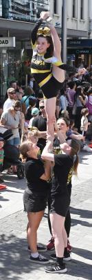 Eclipse cheerleader Indi Fairley Smith, 12, tops the tower during a moving demonstration of skill...