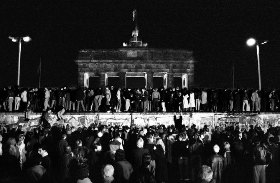 Germans celebrate the fall of the Berlin Wall in 1989. Photo by Reuters.