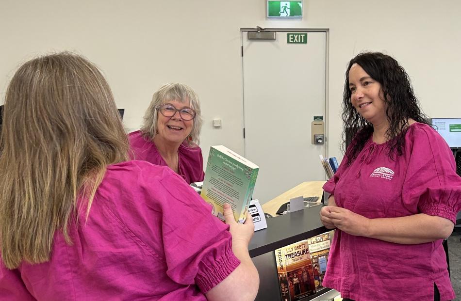 Revealing in their newly refurbished work space are, from left, library assistant Jaimie Phipps,...