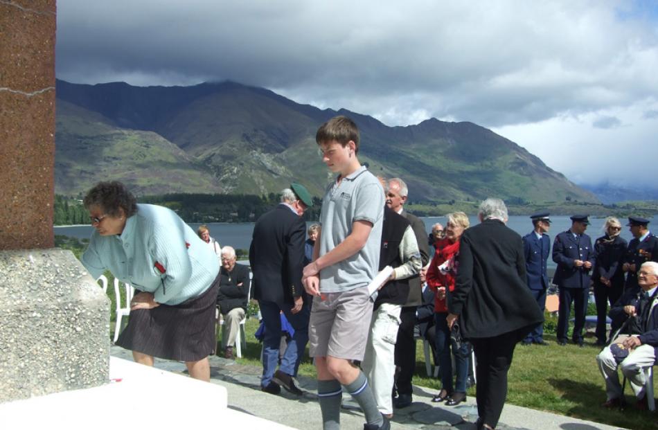 Mount Aspiring College pupil Luke Burke (14) prepares to lay a poppy on the Wanaka memorial after...