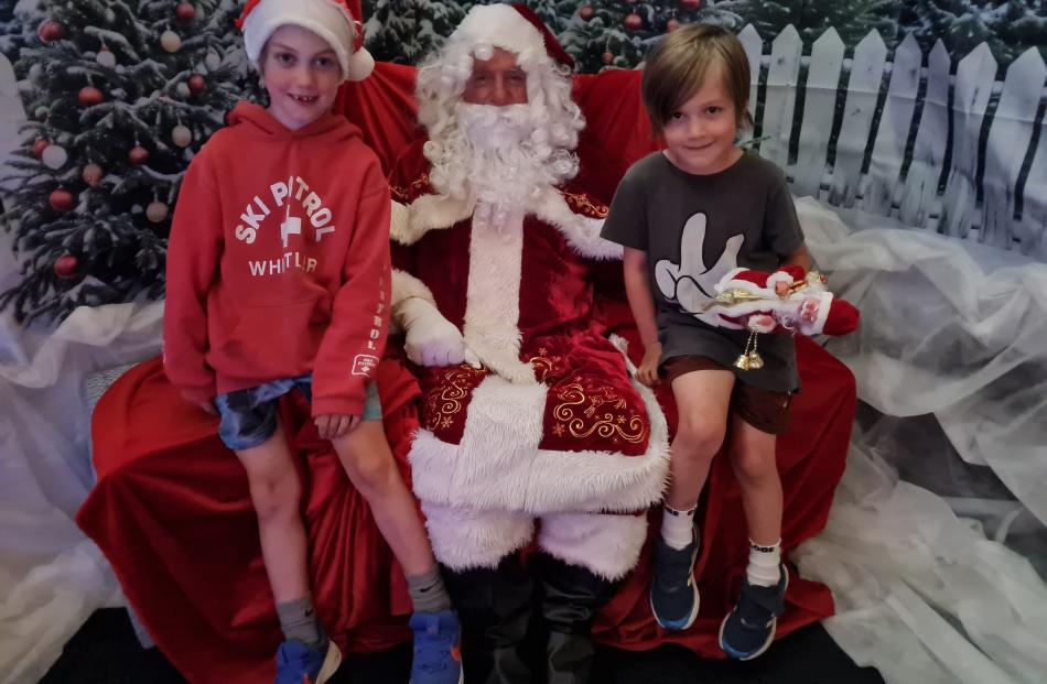 Austin Peden, 7, (left) Santa (Tony Broek), and Weston Peden, 5.