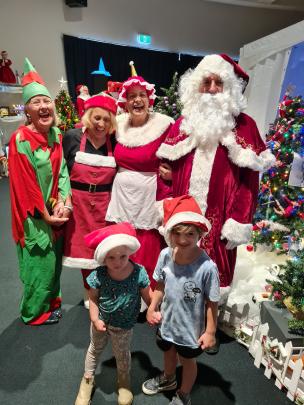 Elves Wendy Broek, Dorothy McDonald, Mrs Claus Jen Anderson and Santa Claus Tony Broek, with...