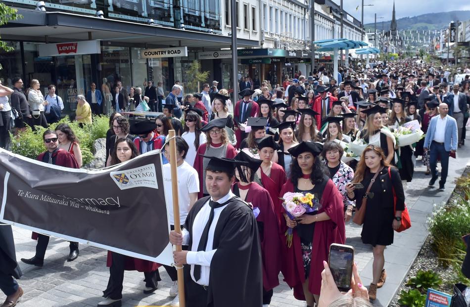 The graduation parade makes its way down George St.