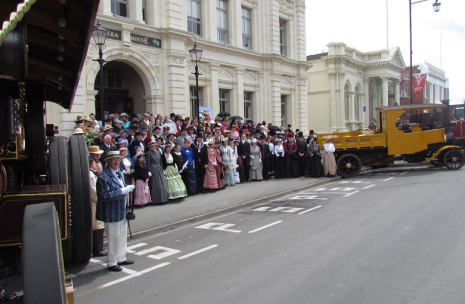 Steam engines and trucks gather with people for a big photo opportunity outside the Oamaru Opera...