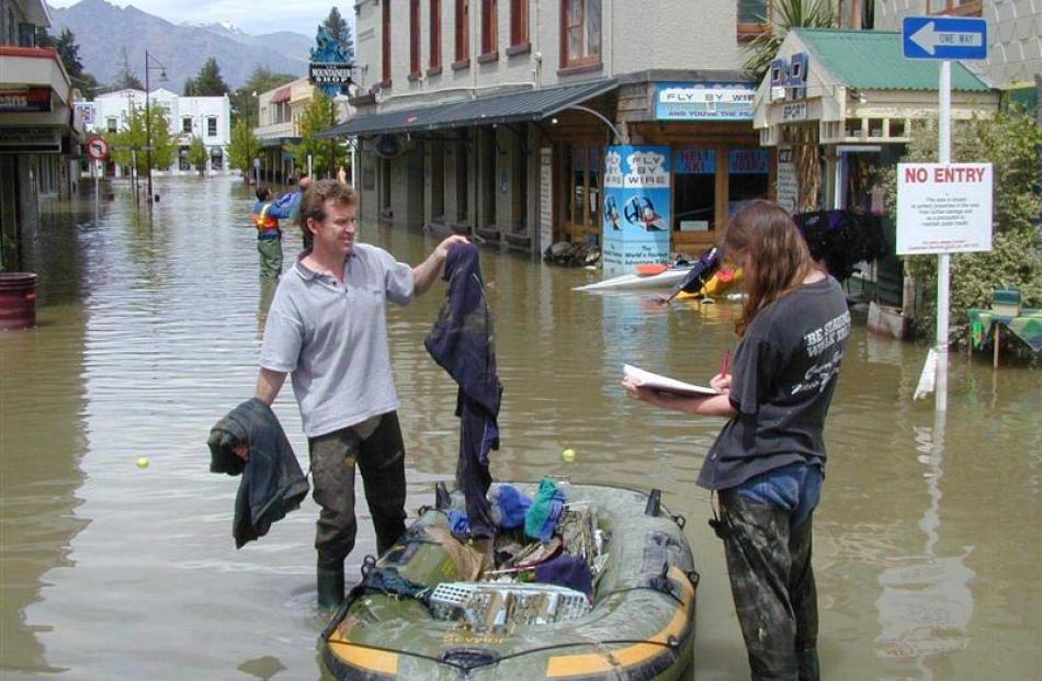 Ian Bell and Sonya Tamblyn clean up outside their Rees St store.