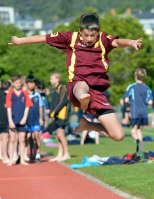 Douglas Smith (11), Manitoto school, competes in the long jump at the Otago primary schools...