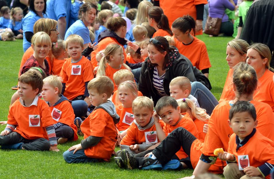 Green Island Kindergarten pupils yesterday wait patiently  for their photo to be taken as part of...