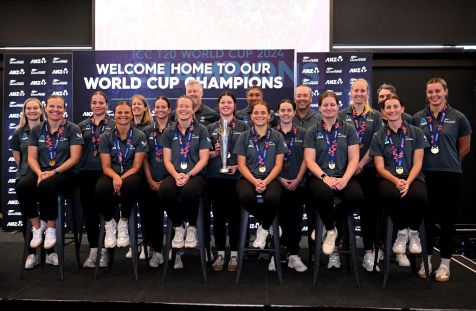 The T20 World Cup-winning White Ferns pose for a photo following their return home to...