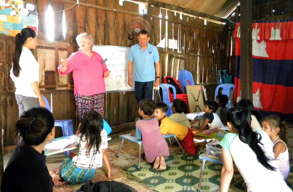 Joan Hasler and Peter Buxton teach Cambodian pupils.