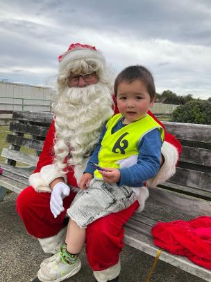 Pleased to meet you ... Lincoln Evans, 2, meets Santa for the very first time outside the St...