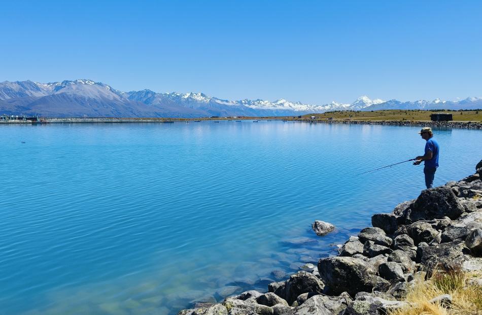 Great day ... Richard Ogier fishes at the Fish Bowl in the Mackenzie Country, with Aoraki/Mt Cook...