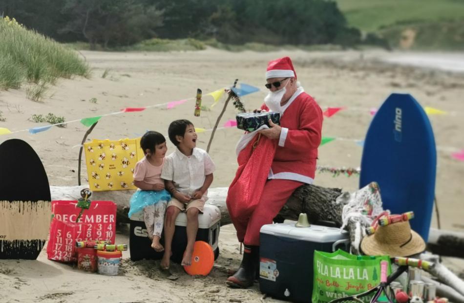 Christmas cheer ... River, 3, and Maddox, 5, Wills, of Alexandra, are excited as Santa hands out...