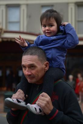 Annastasia Studer-Mark, 2, of Invercargill, surveys the festivities from the shoulders of her...