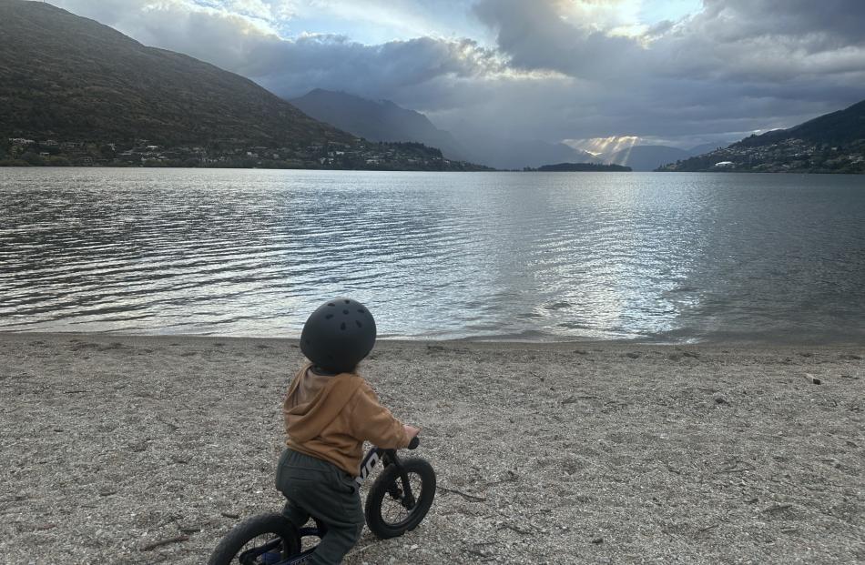Maui’s ropes ... Maddox Thompson, 2, stops to watch the final rays of the sunset pierce through...