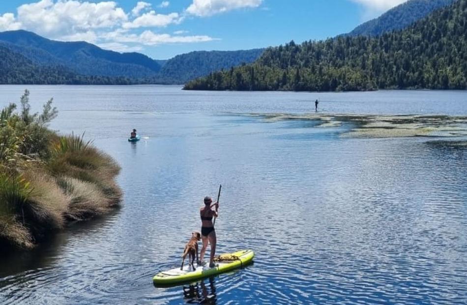 Rendezvous ... Katarina Milne, of Nelson, paddles with dog Buddy to meet her sister, Marijke...