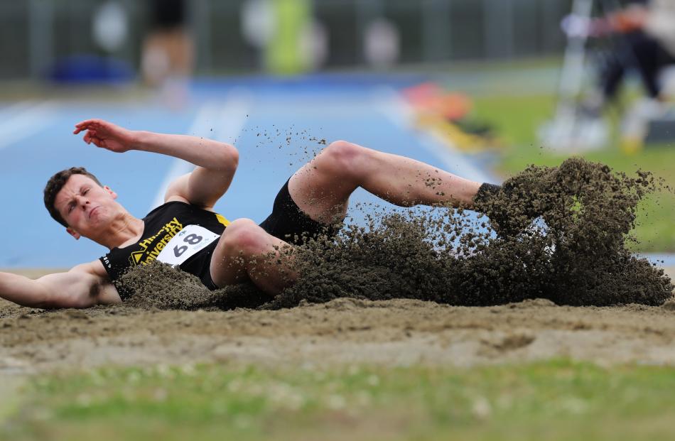 Hill City-University athlete Luke Moffitt hits the sand in the men’s long jump.