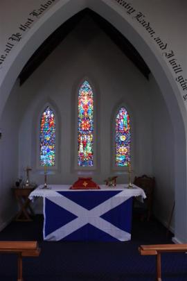 Light shines through stained-glass windows in  St Andrew's Anglican Church.