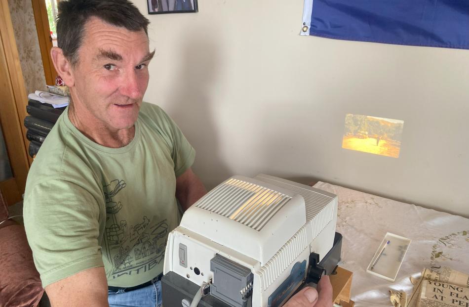 Craig Matheson views his grandma’s photographs of a flash flood in 1975. PHOTO: SHELLEY INON