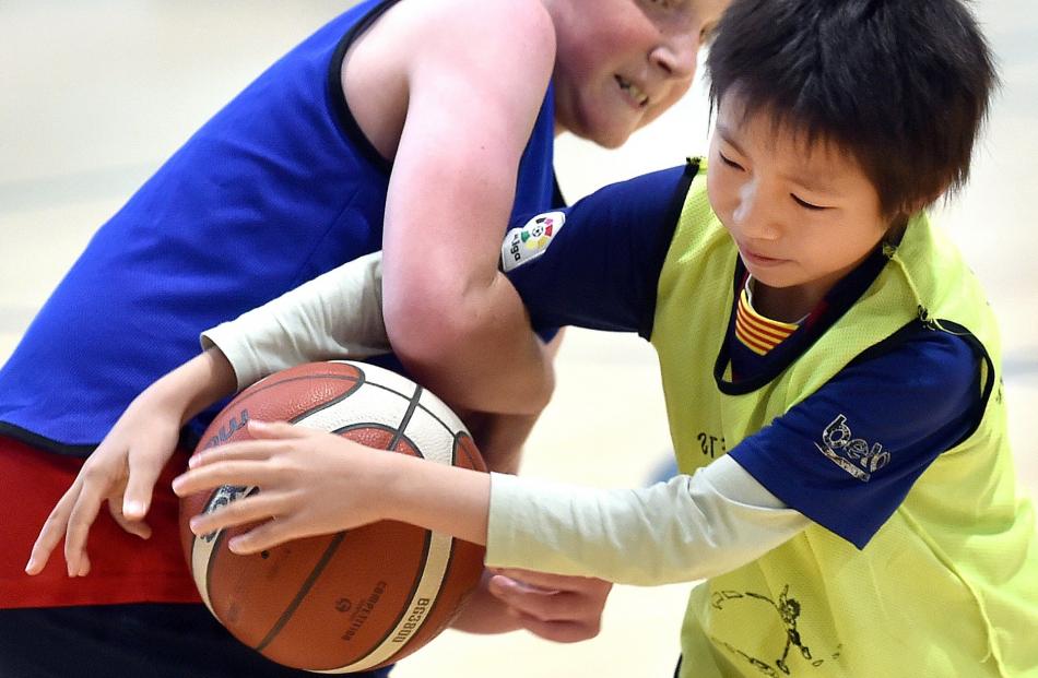 Ben Hollows, 10, applies a bit of aggressive offence while attempting to rip the ball out of the...