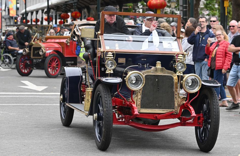 A 1908 Talbot Roadster, owned by Stephen Kidd, drives past spectators.