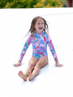 Eliza O’Neil, 7, of the North Island, enjoys the rodeo’s water slide.