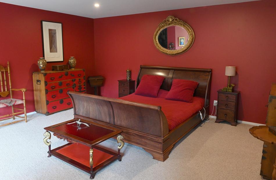 The main bedroom is painted Resene Paprika. The owners say they have always had houses with a lot...