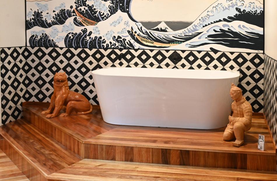 One of the owners of the house painted the scene of a boat moving through a storm-tossed sea, in...