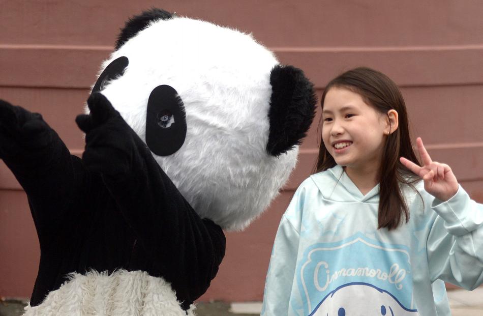 Gisele Sew Hoy, 10, poses with a panda mascot for Chinese New Year celebrations at Lan Yuan.