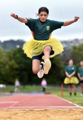Bayfield High School student Violet Moir, 13, takes flight in the long jump at the school’s...