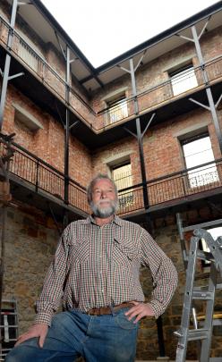 Bruce Purvis stands in the internal full-height atrium that acts as a diaphragm for the building.