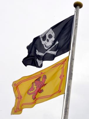A skull and bones flag flies above the Caledonian Bowling Club flag yesterday.