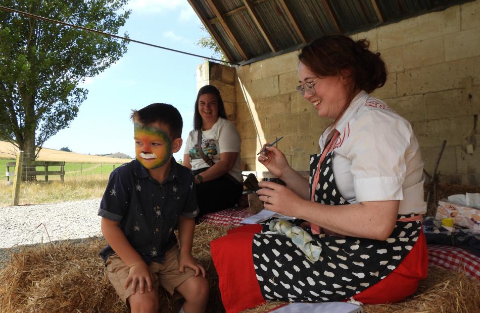 Kowhai Olsen, 5, checks himself in the mirror, as mum Saia Olsen (back) looks on. Heritage NZ...