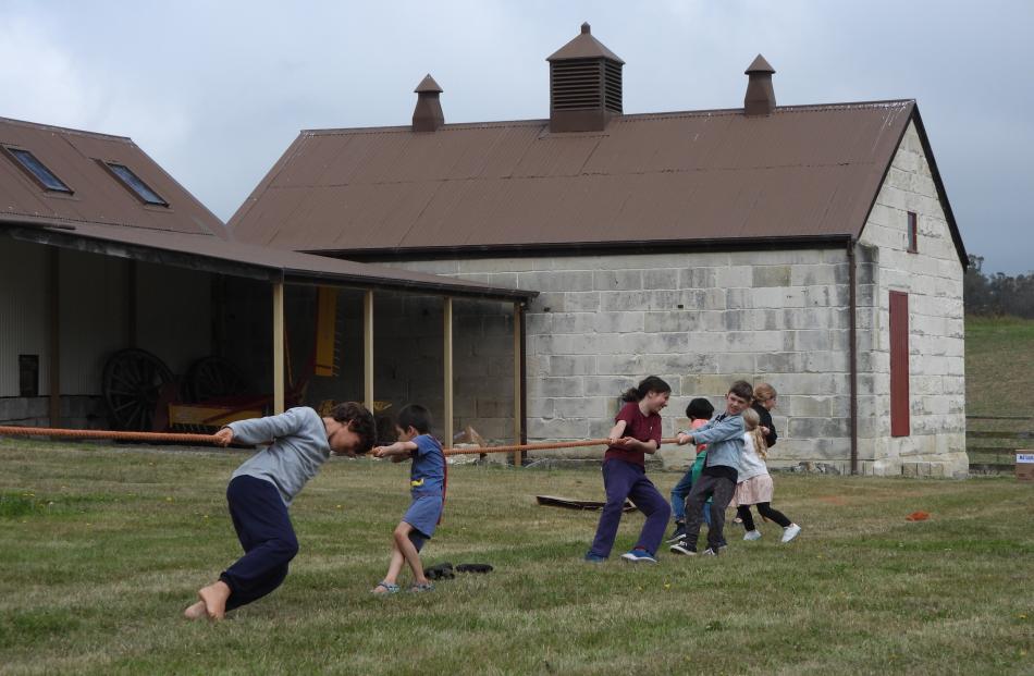 Children expend their energy in the tug-of-war.