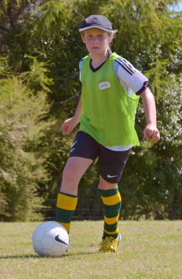 Emily Templeton (9), of Alexandra, dribbles the ball.