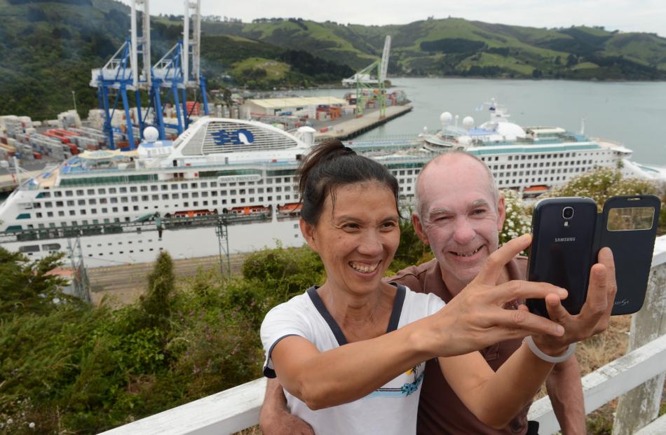 Passengers Chuang Fong and Murray Tait-Kong pose for a photograph in Port Chalmers yesterday.