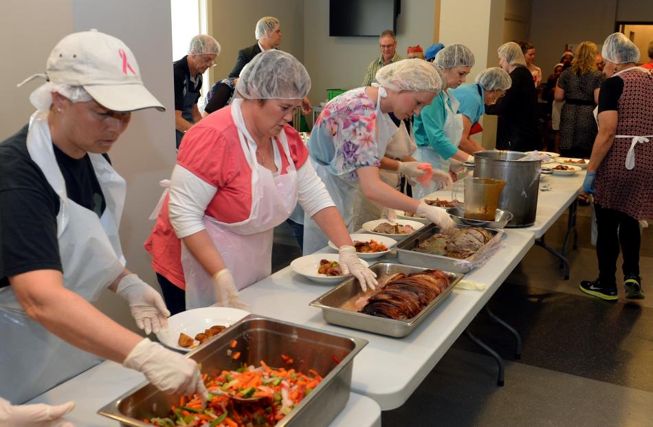 Volunteer caterers dish out the food.
