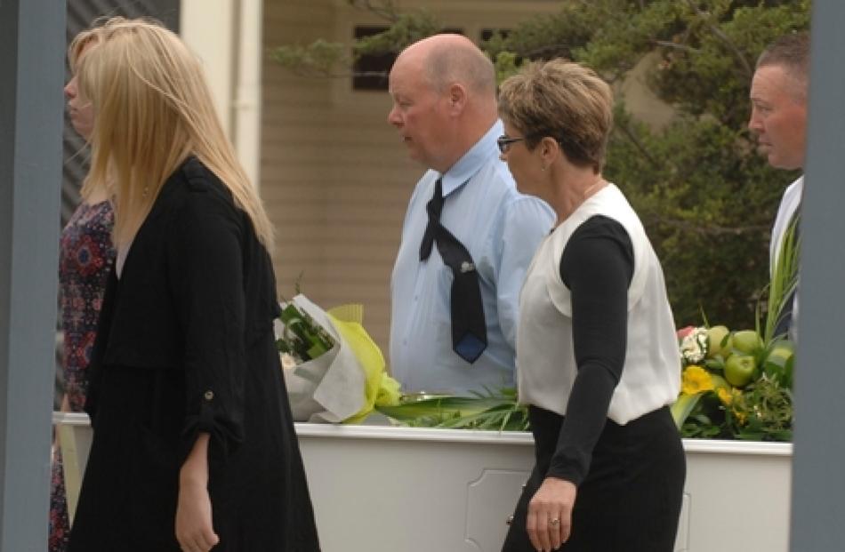 achel's parents, Tony and Judy Clark, centre, help carry her coffin after the service at Cromwell...