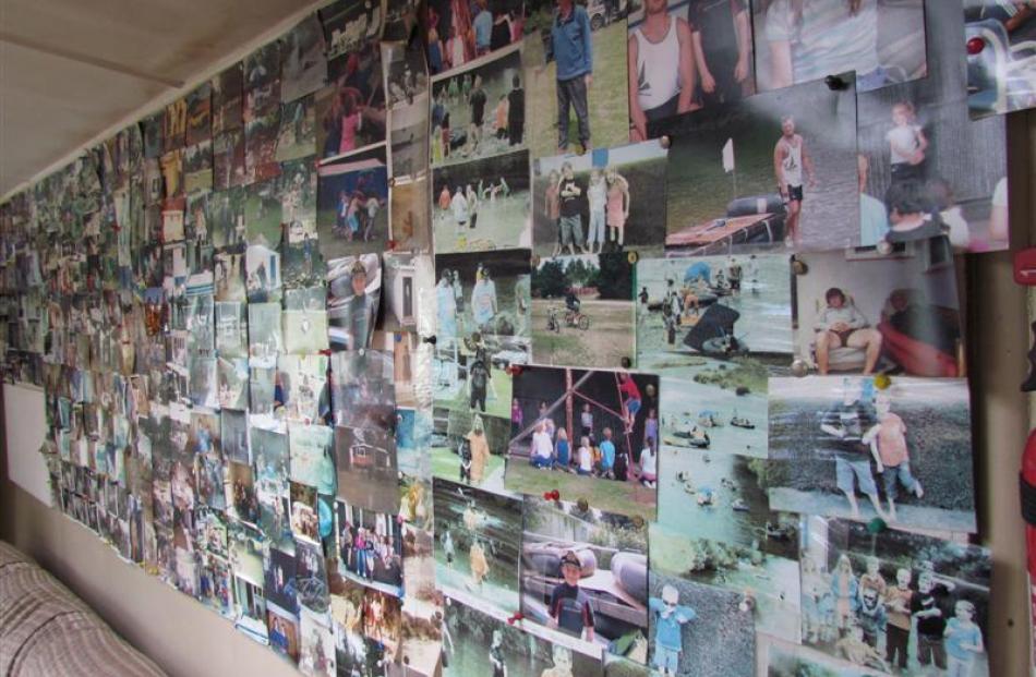Part of one of two walls covered with photographs of family and camp events. Photos by David Bruce.