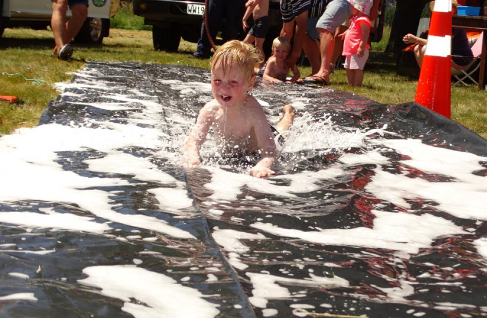Logan Davidson (3), of Wanaka, finds a way to keep cool at the races.