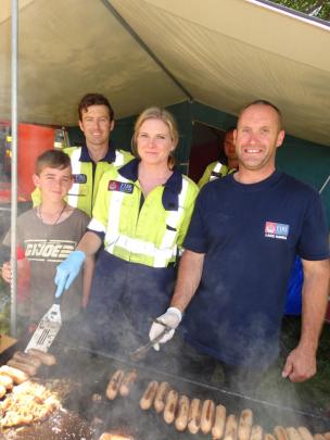 Volunteering at the Lake Hawea Volunteer Fire Brigade sausage sizzle stand are (from left)...
