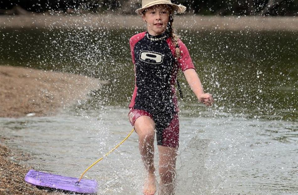 Zara Adamson (9), of Mosgiel, cools off at Outram Glen on Saturday.