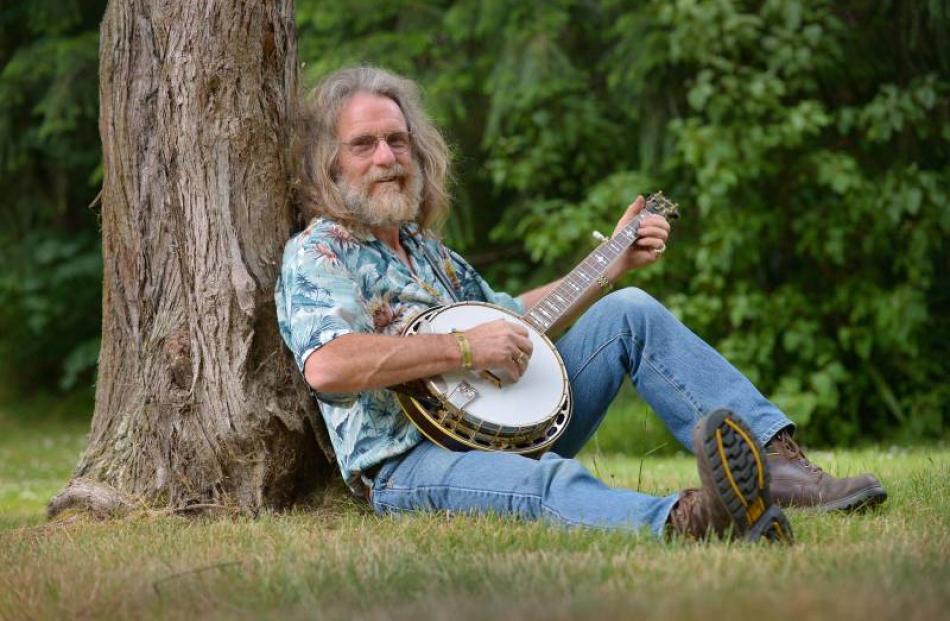 Dunedin banjo enthusiast Robbie Stevens picks out a tune as he waits for his fellow Valley...